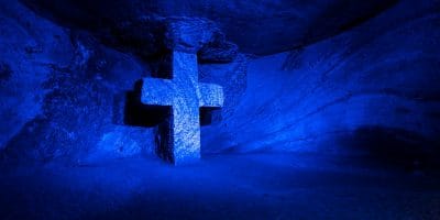cross in a cave with blue light